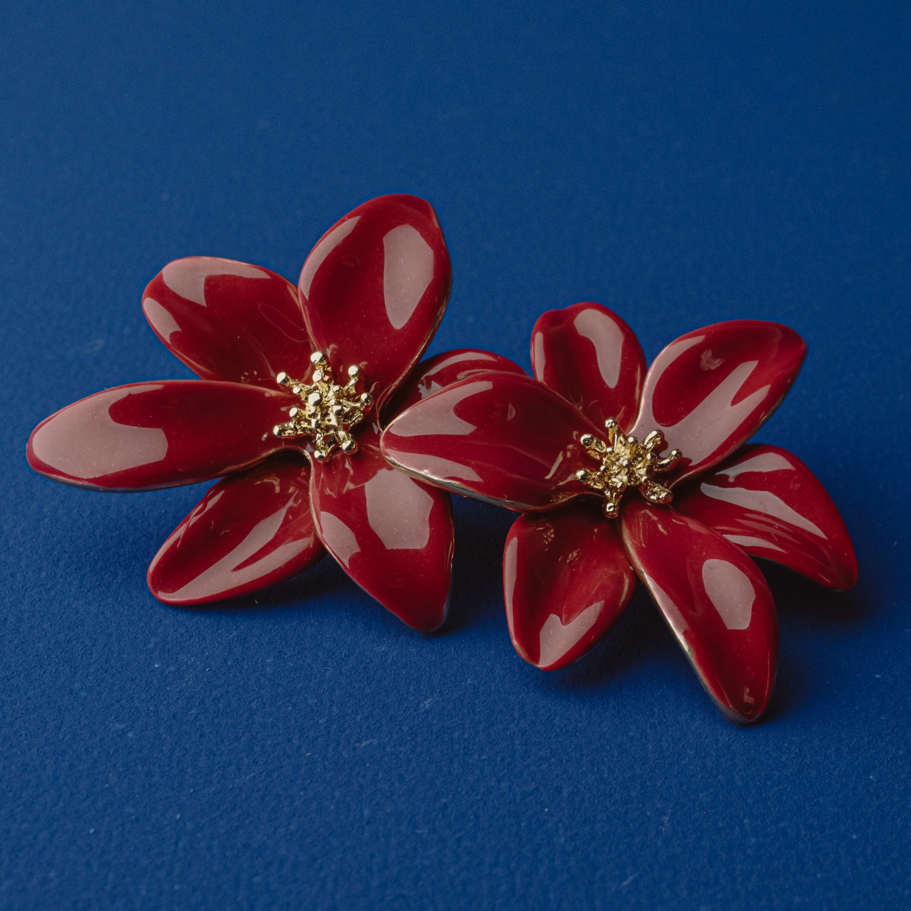 Red enamel tropical flower earrings