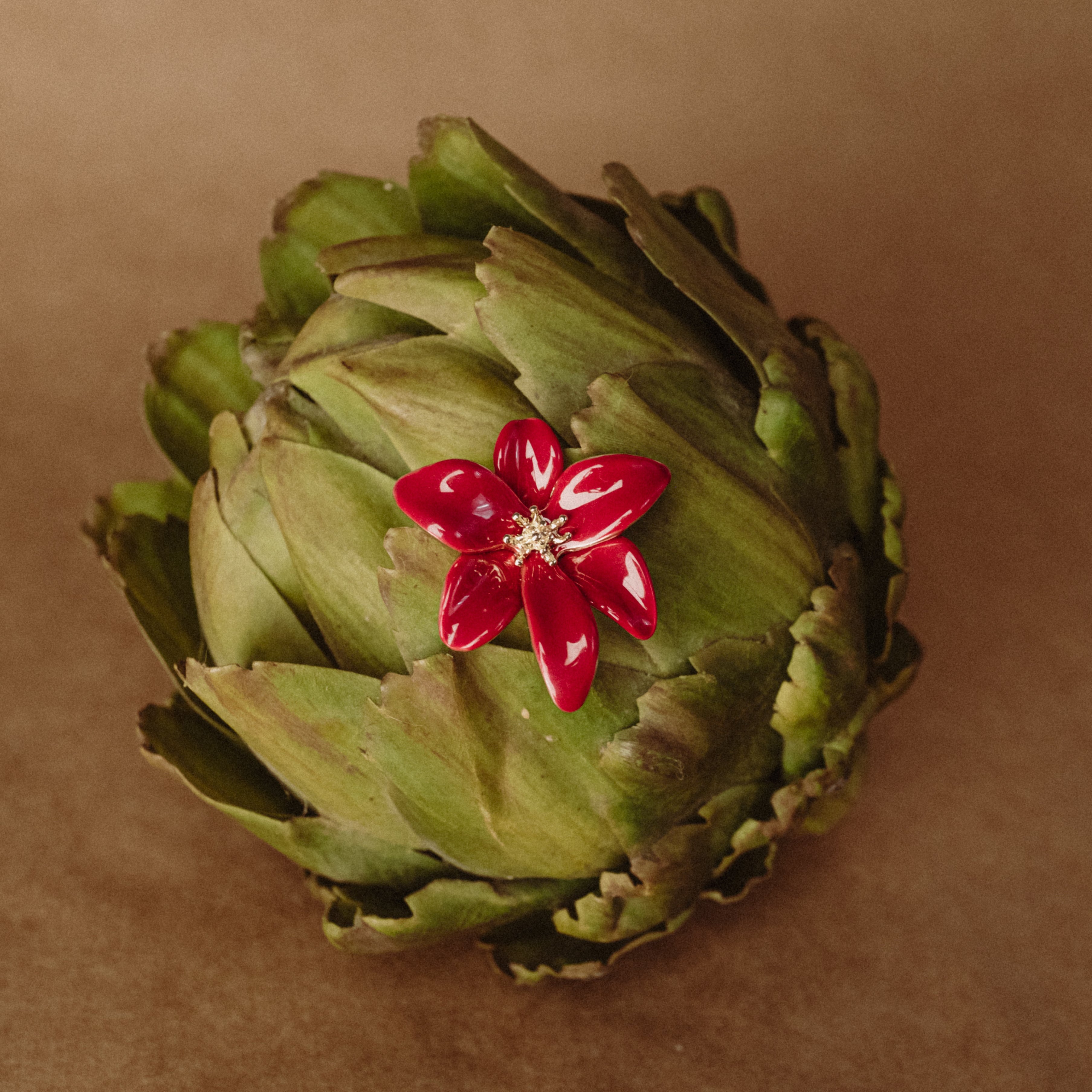 Rhubarb red tropical flower earring styled in an artichoke