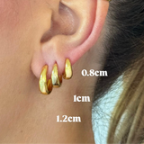 Gold hoop earrings displayed on an ear with size measurements.