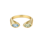 A gold open ring band featuring two marquise-cut gemstones, one light blue and one pale green, set in a ribbed wrap design on a light beige background.