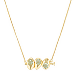 Gold necklace with three green gemstones on a white background