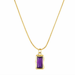 Gold necklace with a purple gemstone pendant on a white background