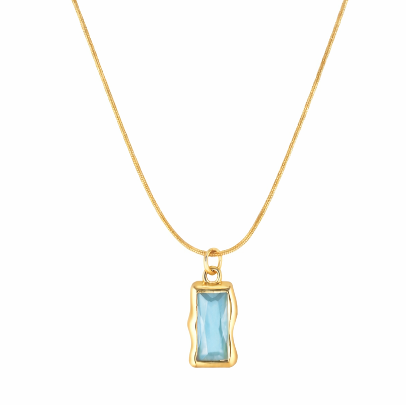 Gold necklace with a blue gemstone pendant on a white background