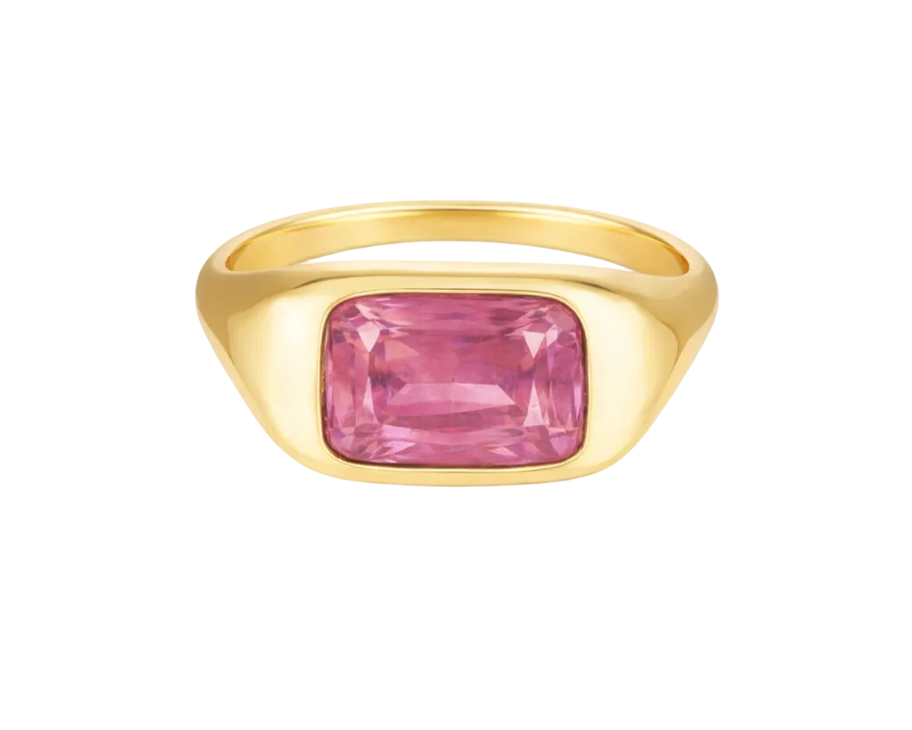Gold ring with a pink gemstone on a white background