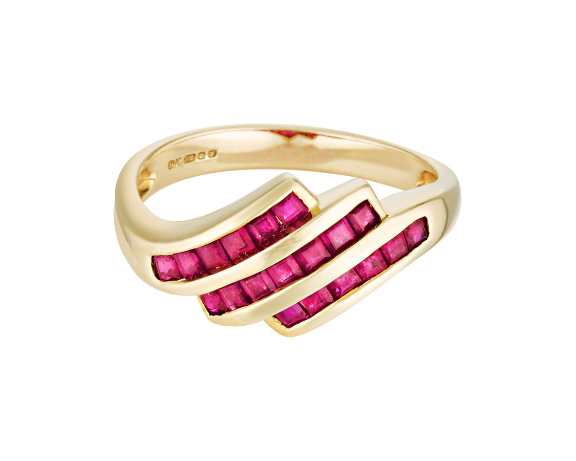 Gold ring with pink gemstones on a white background
