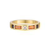 Gold ring with embedded gemstones on a white background