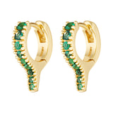 Gold hoop earrings with green gemstones on a white background