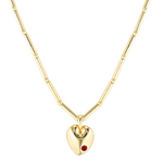 Gold heart-shaped necklace with a red gemstone on a white background