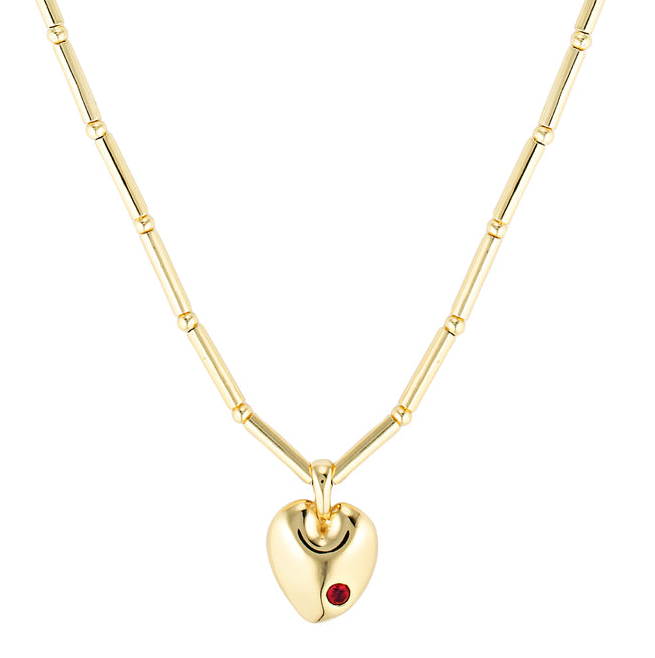 Gold heart-shaped necklace with a red gemstone on a white background