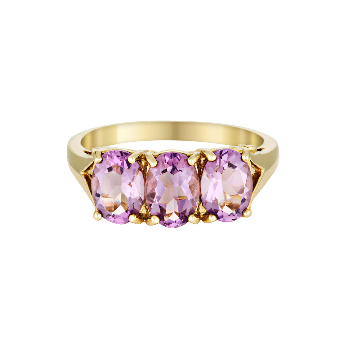Gold ring with three pink gemstones on a white background