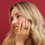 Woman wearing a ring with a red background