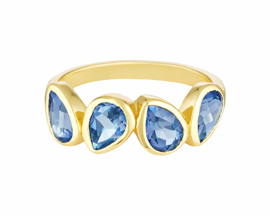 Gold ring with blue teardrop-shaped gemstones on a white background