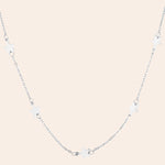 Silver necklace with star-shaped pendants on a white background