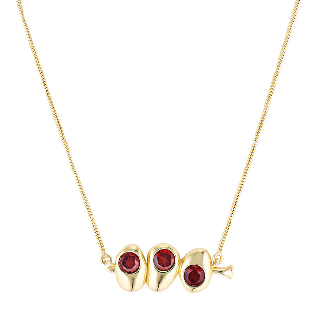 Gold necklace with three red gemstones on a white background