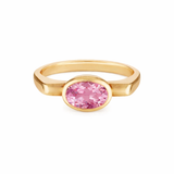 Gold ring with a pink gemstone on a white background