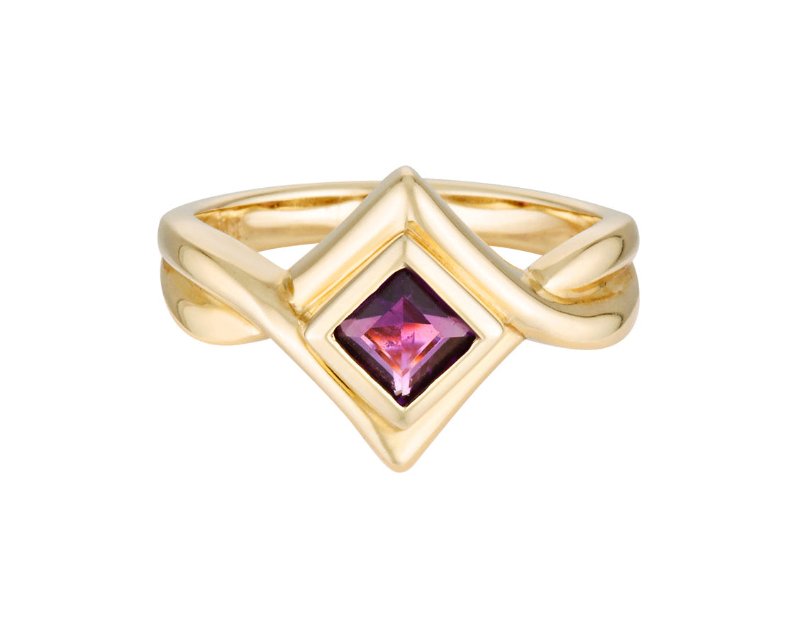 Gold ring with a pink gemstone on a white background