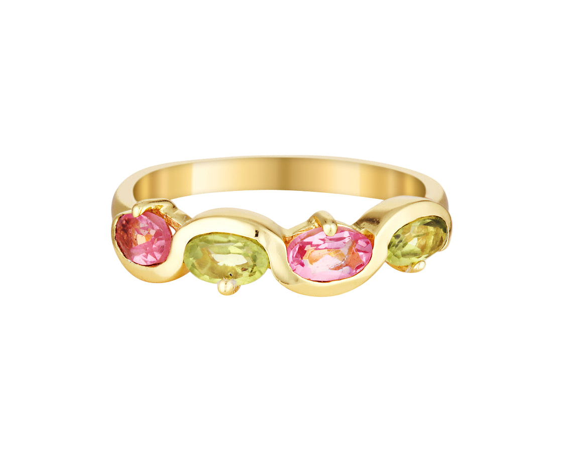 Gold ring with pink and green gemstones on a white background
