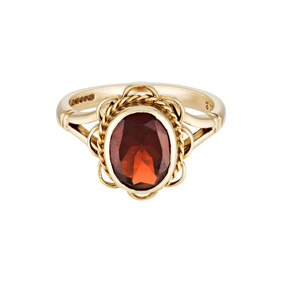 Gold ring with a red gemstone on a white background