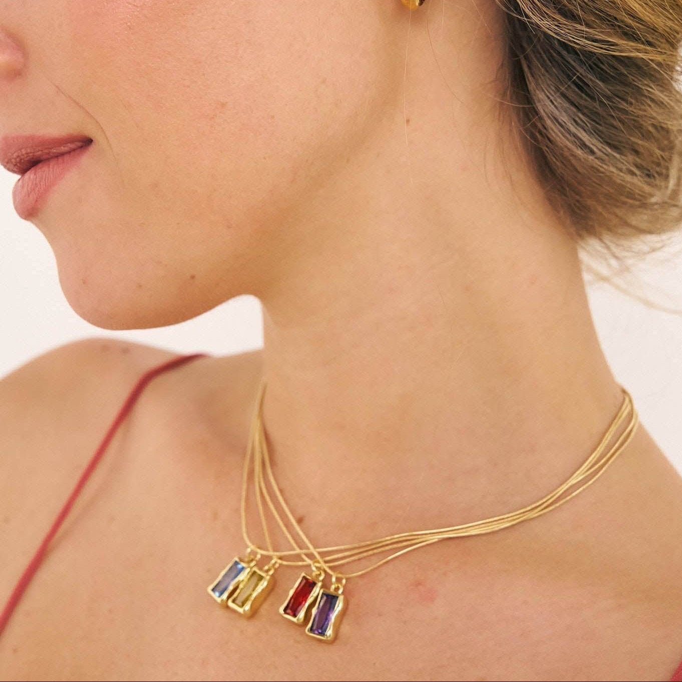 Model in coloured birthstone necklaces