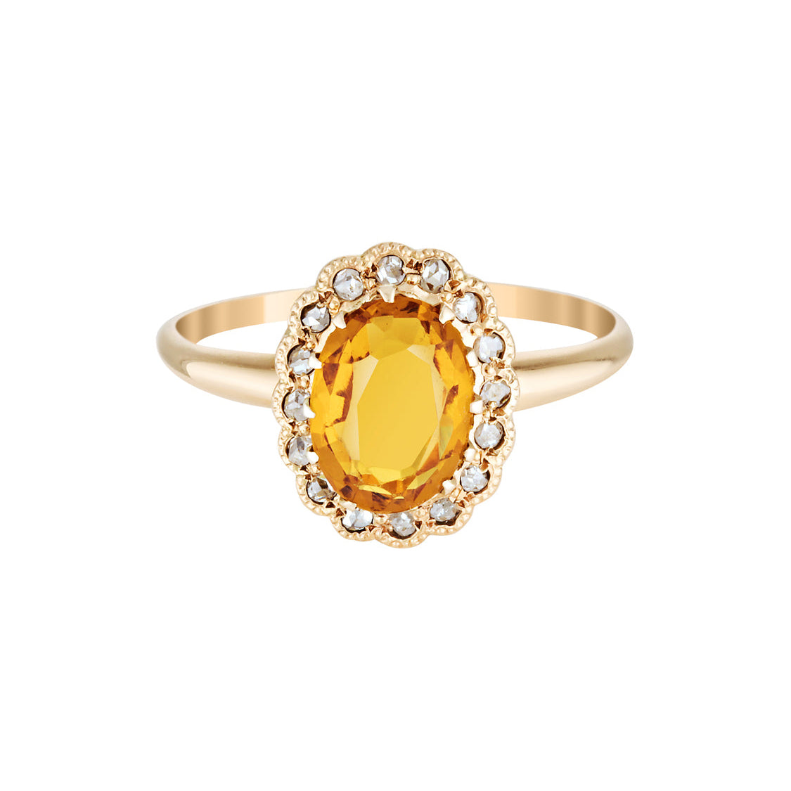 Gold ring with a yellow gemstone on a white background