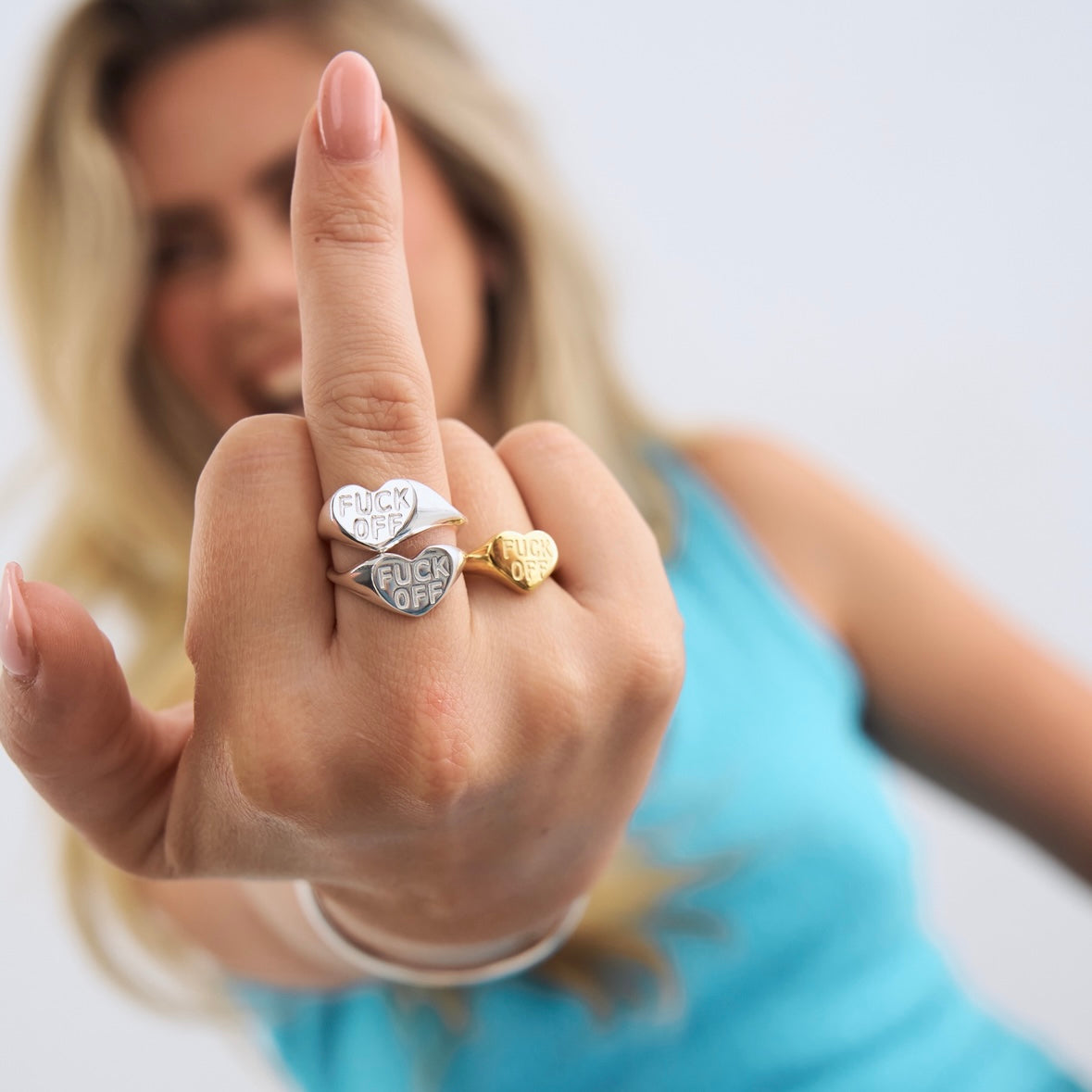 Model showing silver Fuck off ring on her middle finger 