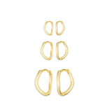 Set of gold hoop earrings on a white background
