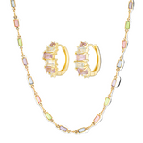 Jewelry set with hoop earrings and a chain necklace featuring multicolored gemstones on a white background.