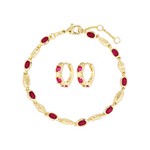 Gold bracelet and earrings with red stones on a white background