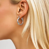 Model wearing silver Chatsworth Hoops | hoops style earrings with bright coloured gemstones 