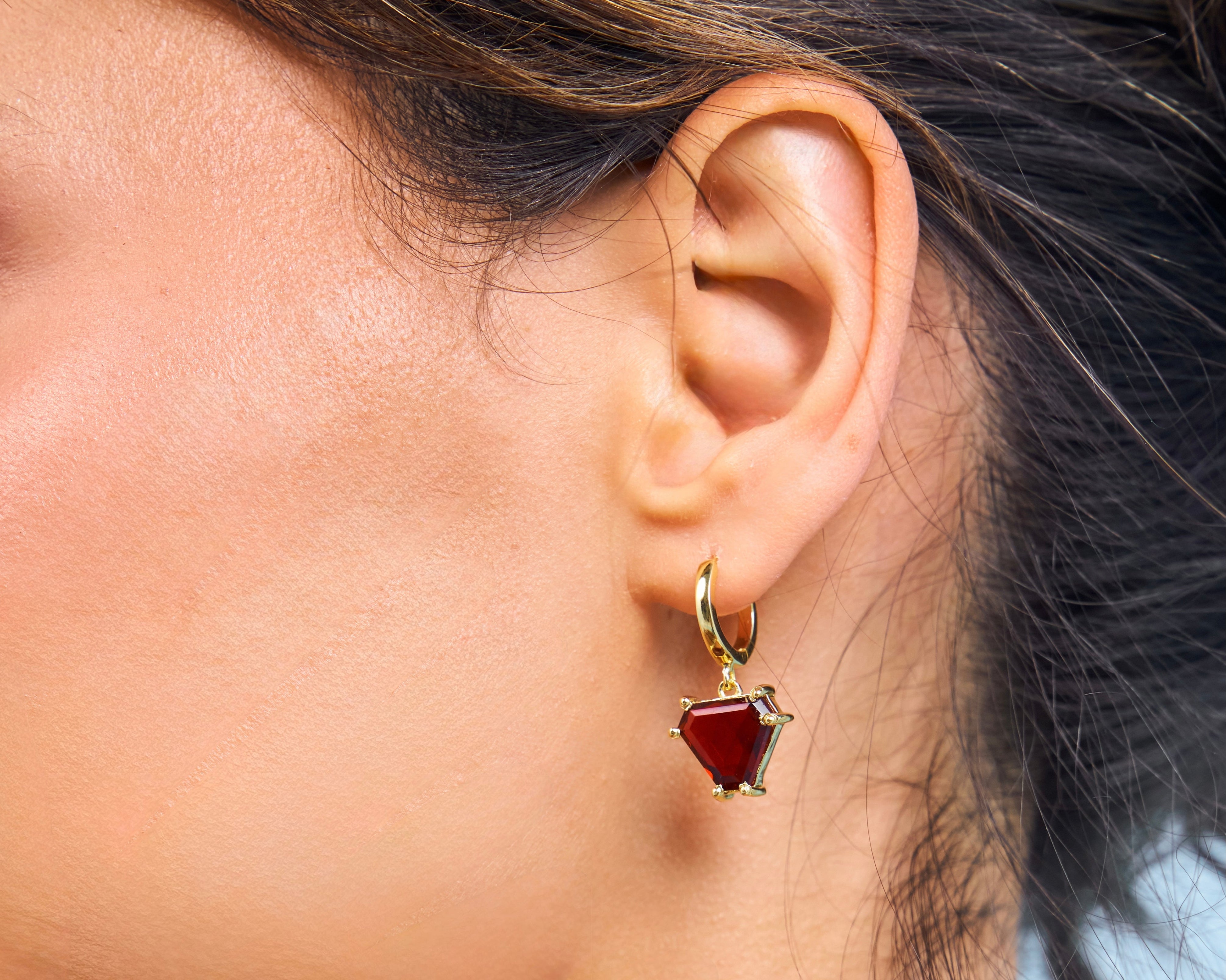 Close up of garnet bright red gemstone hoops in 18k vermeil gold 