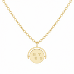 Gold necklace with a round pendant on a white background