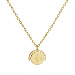 Gold necklace with a round pendant on a white background