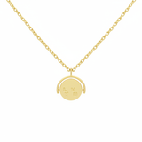 Gold necklace with a round pendant on a white background