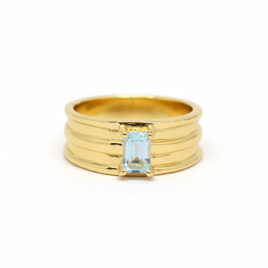 Gold ring with a rectangular blue gemstone on a white background