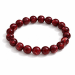 Red beaded bracelet on a white background