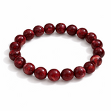 Red beaded bracelet on a white background