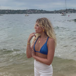 video of Bixby model by the sea in our waterproof earrings and necklace