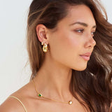 Model wearing Bottega shaped earrings